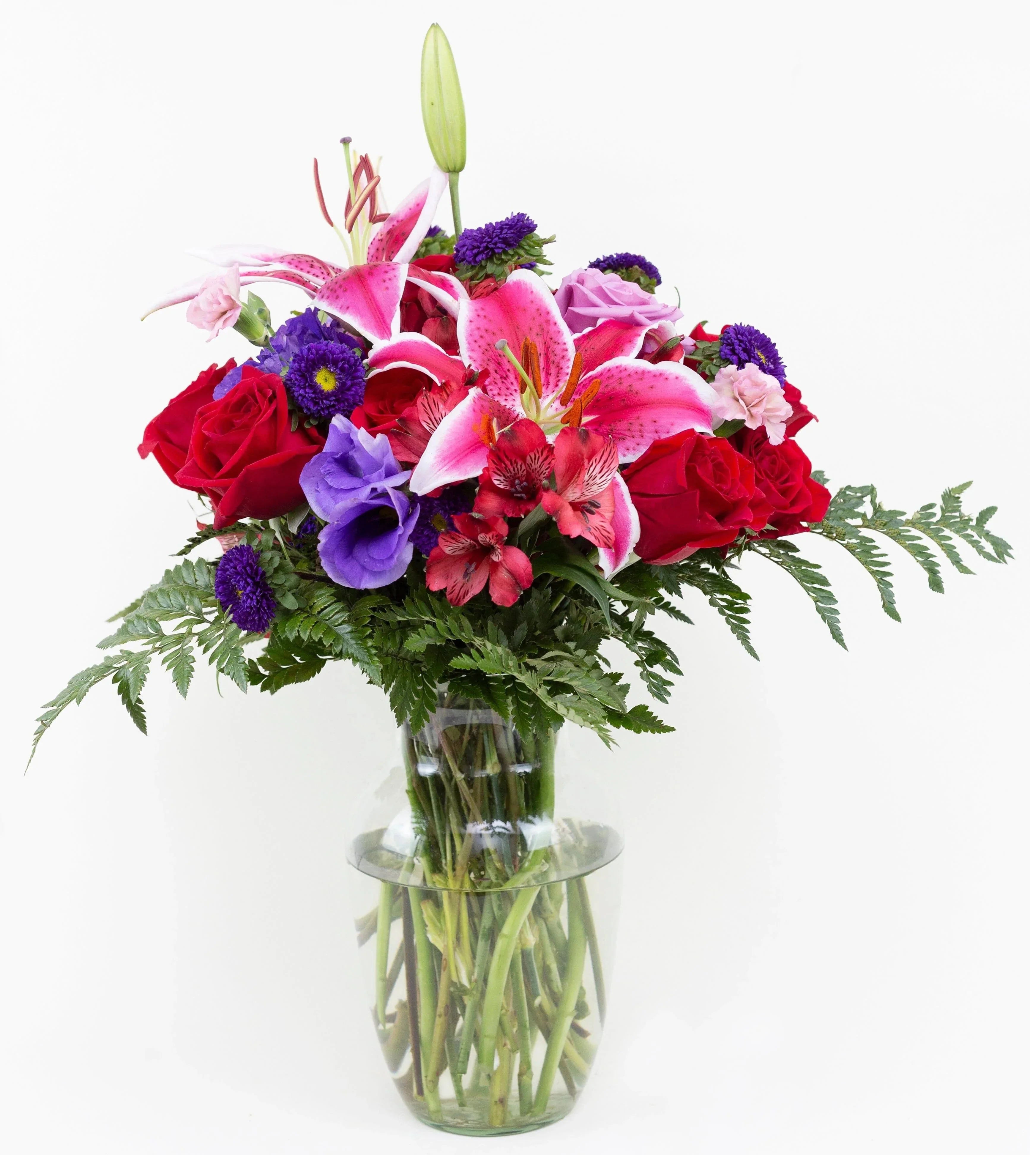 Array of Blooms -red roses , lavender carnations , red lilies , purple lisianthus , purple matsumoto asters , greens , vase arrangement