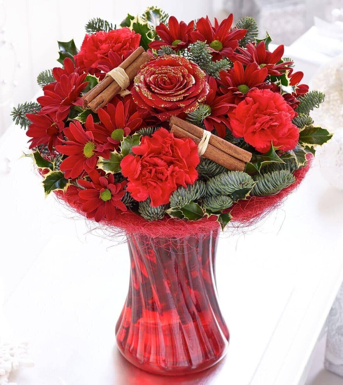 Christmas Perfect Gift - red roses , red carnations , red chrysanthemums , holly , spruce , salal , cinnamon , vase arrangement