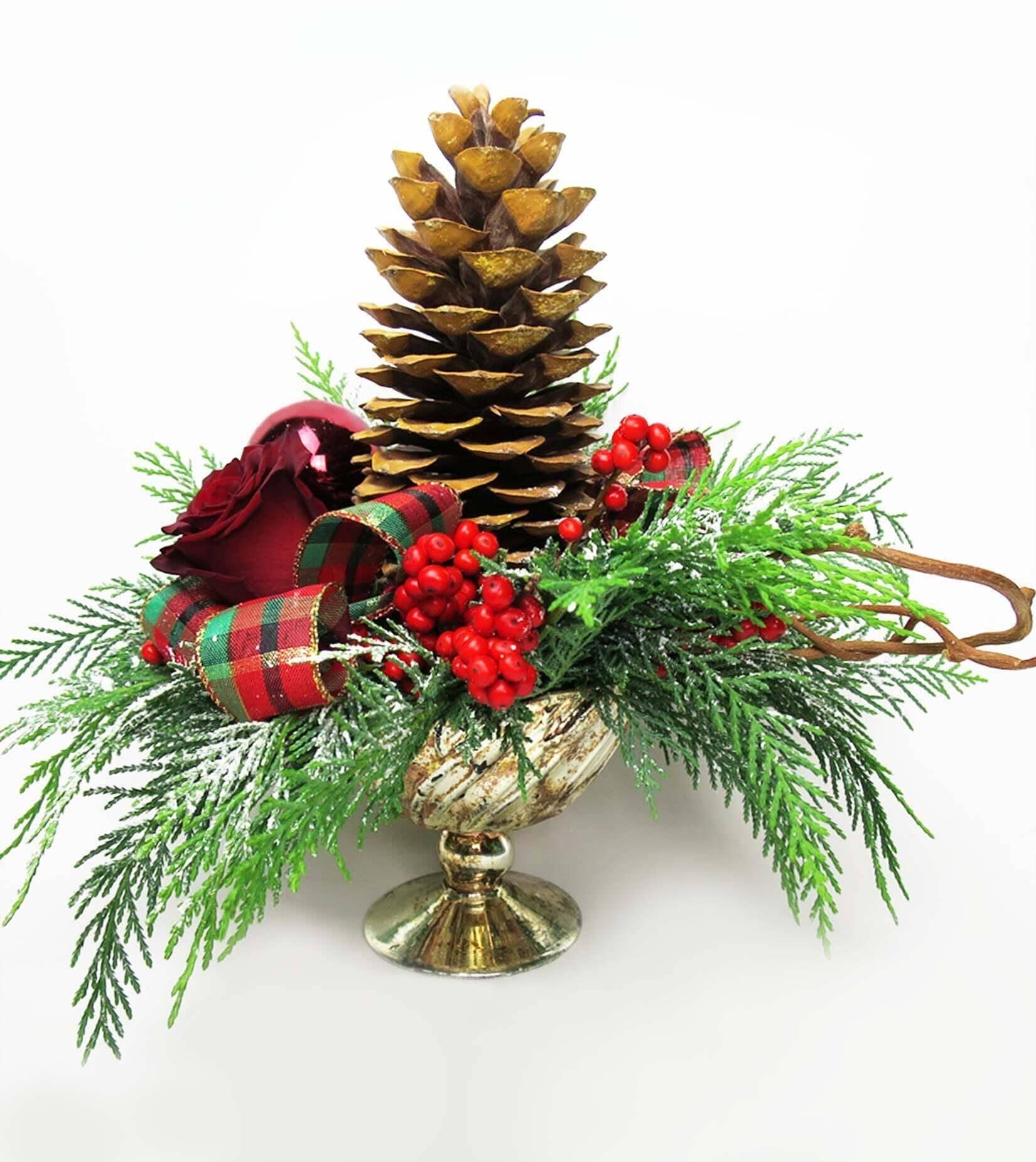 Cone and Berries - vase with large cone, this arrangements consists of red ilex berries and roses, bows, kiwi vines and evergreens