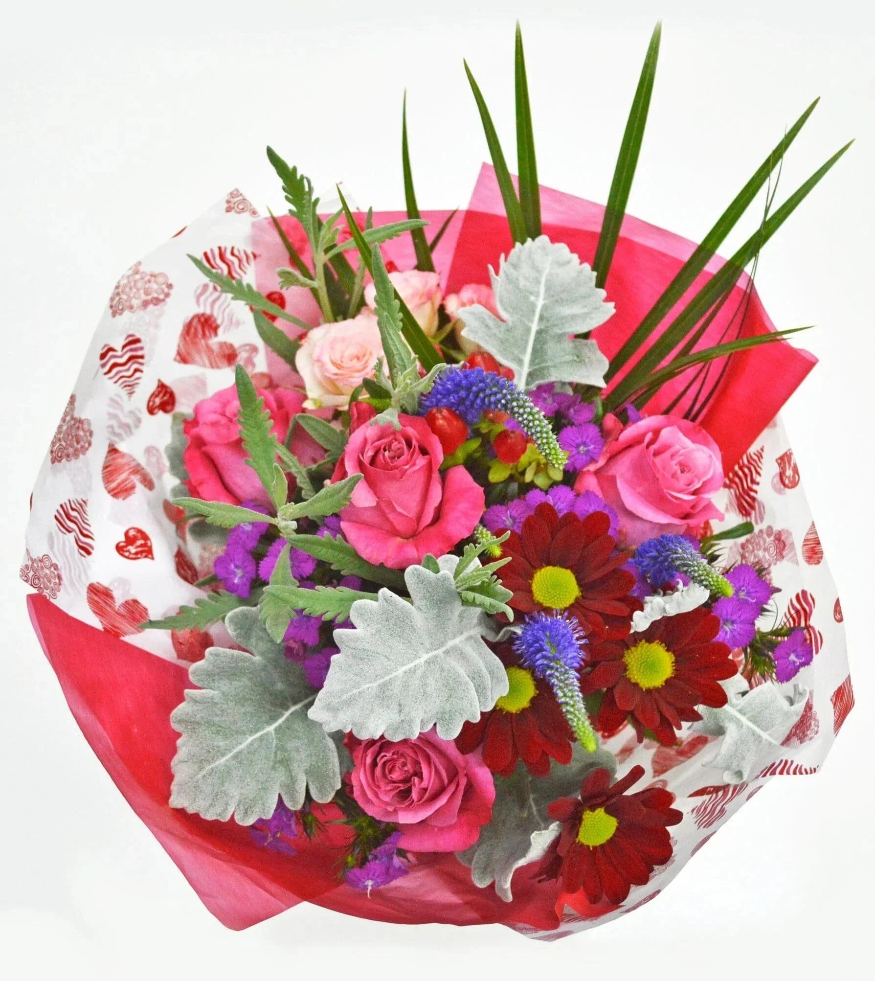 Dear Juliet™ Bouquet by Toronto Flower Co. is a love-inspired design featuring blooms in shades of pink, purple and red accented by delicate foliage like dusty miller.