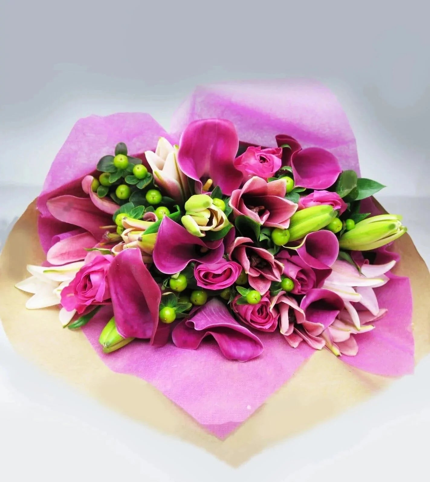 Favourite Pink Expressions™ Bouquet - bouquet of Fuchsia roses, Pink Mini Callas and Asiatic Lilies are arranged with Green Hypericum and Ruscus