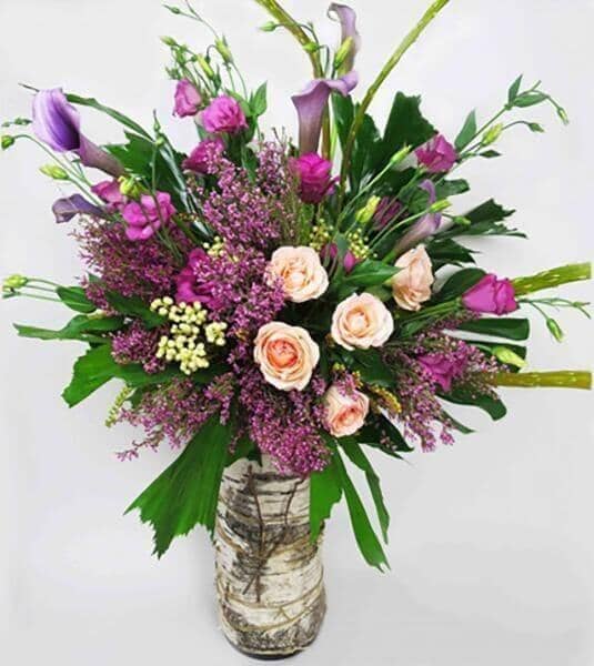Grandeur of Nature™ -roses, lisianthus, mini callas, heather, berzelia lanuginosa, twigs and lush foliage