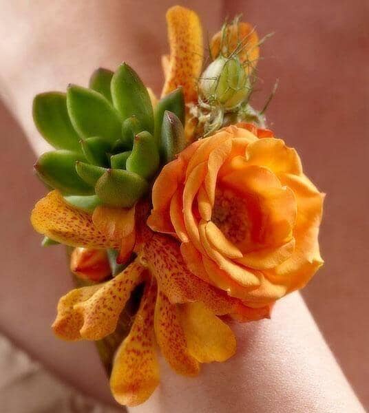 Irresistible Love Wrist Corsage - orange spray roses , orange mokara orchids , green foliage , succulents , nigella pods , peach berries , amber taffeta ribbon , corsage , wedding , prom , graduation