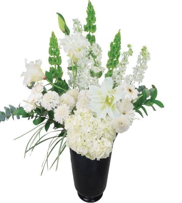 Sensation Arrangement - white rose lilies, hydrangeas, larkspur, gerbera, scabiosa, bells of Ireland and luscious greens in a black mercury glass vase