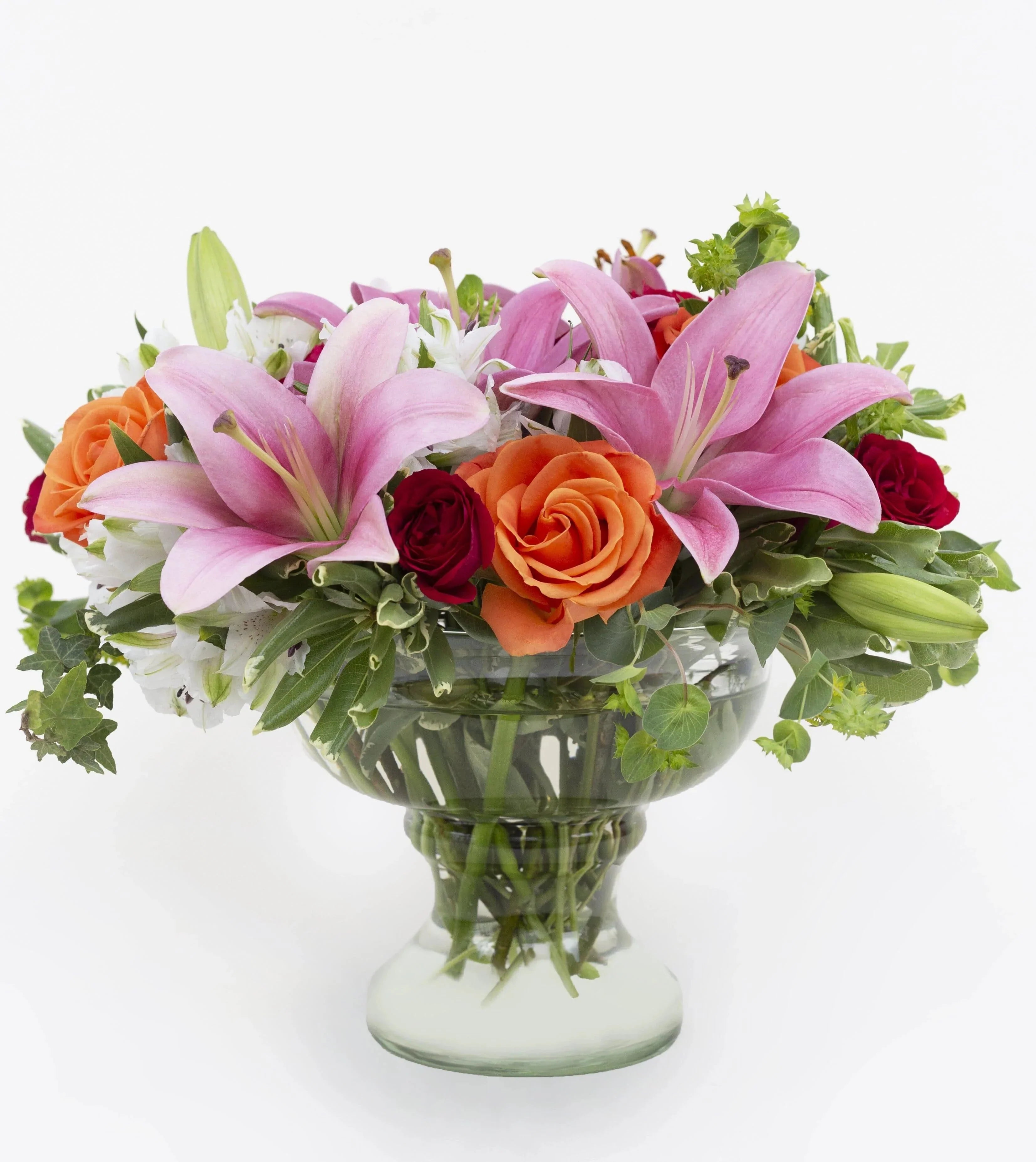 Simple Surprises Bouquet By Vera Wang Standard - Orange roses, pink oriental lilies, red spray roses, white alstroemeria, bupleurum , pittosporum variegated