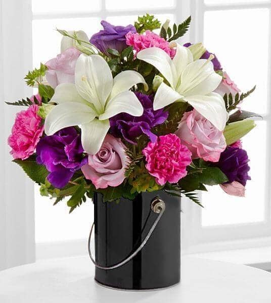 The Color Your Day With Black Beauty™ Bouquet - paint can includingLavender roses, fuchsia carnations, purple double lisianthus, white Asiatic lilies, bupleurum and lush greens