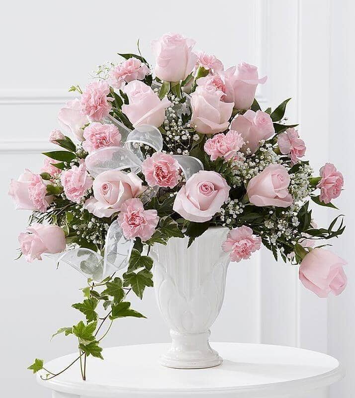 Deepest Sympathy™ Arrangement - vase with Pale pink roses and pink carnations are offset by baby’s breath, variegated ivy, lush greens