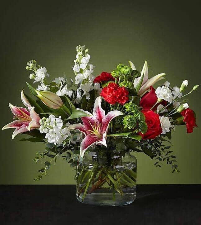 Peppermint Swirl™ Bouquet by Toronto Flower Co. is an elegant holiday arrangement designed by hand in a vase with stargazer lilies as its protagonist.