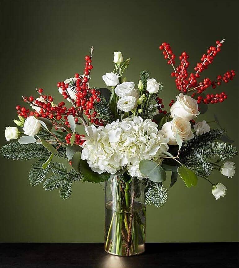 Winter Forest™ Bouquet by Toronto Flower Co. is a festive design with Holiday elements that will bring joy to every home this season. It is made up of a mixture of fresh white flowers such as hydrangeas, roses and lisianthus, accompanied by ilex berries and wooden greenery.